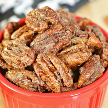Air fryer candied pecans in a bowl, a sweet and crunchy snack.