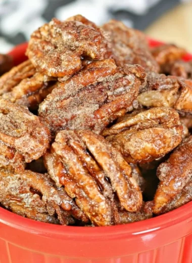 Air fryer candied pecans in a bowl, a sweet and crunchy snack.