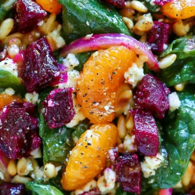 Delicious beet salad with spinach and mandarin oranges served in a bowl