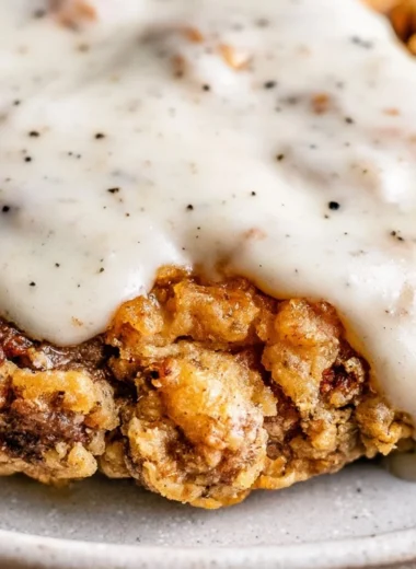 Delicious chicken fried steak served with gravy and sides