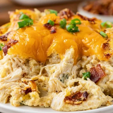 Cozy Crack Chicken Casserole dish with chicken, cheese, and bacon toppings