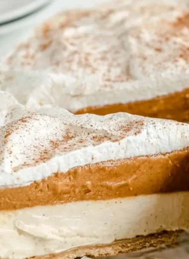 Delicious no-bake pumpkin pie garnished with whipped cream and spices
