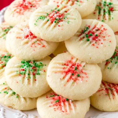 Delicious whipped shortbread cookies on a cozy plate, perfect for the holidays.