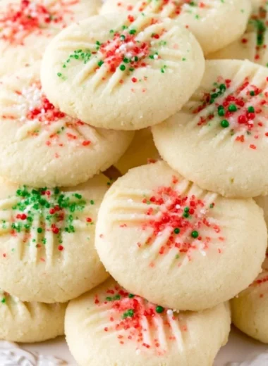 Delicious whipped shortbread cookies on a cozy plate, perfect for the holidays.