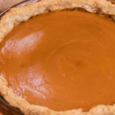 Delicious homemade sweet potato pie topped with whipped cream