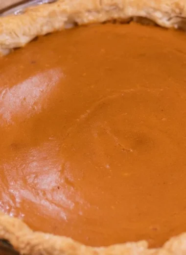 Delicious homemade sweet potato pie topped with whipped cream
