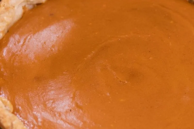 Delicious homemade sweet potato pie topped with whipped cream
