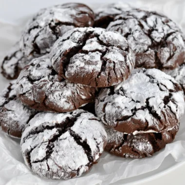 Deliciously baked easy chocolate crinkle cookies with powdered sugar coating