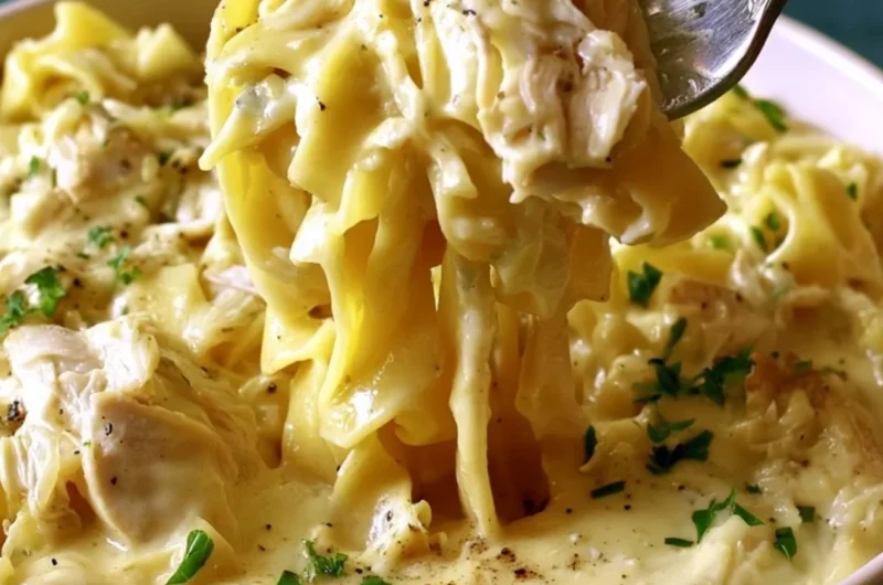 Bowl of easy creamy chicken and noodles garnished with herbs