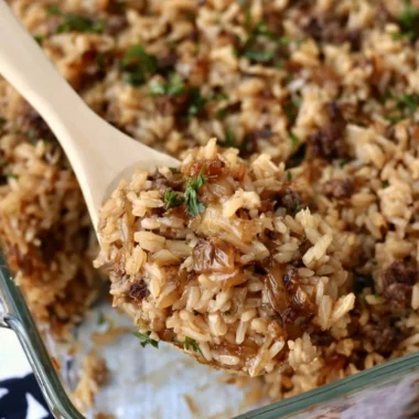 Delicious French onion casserole with ground beef and rice served in a baking dish.