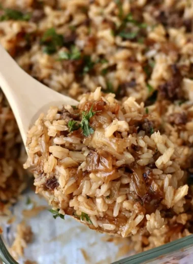 Delicious French onion casserole with ground beef and rice served in a baking dish.