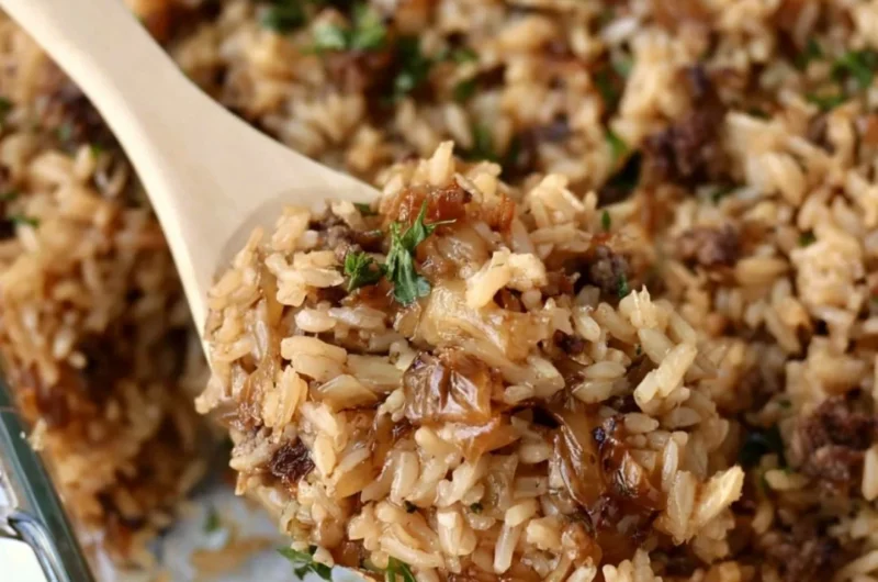 Delicious French onion casserole with ground beef and rice served in a baking dish.