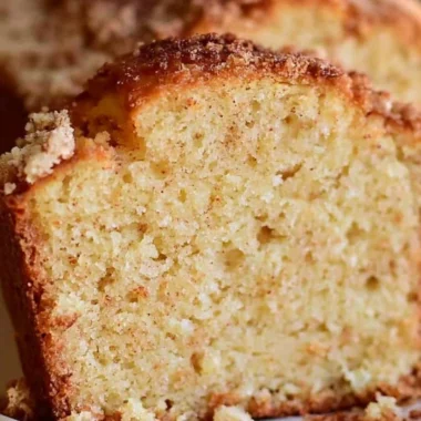 Deliciously spiced Eggnog Loaf topped with holiday decorations