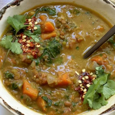 Bowl of Sweet Potato Lentil Stew topped with fresh herbs