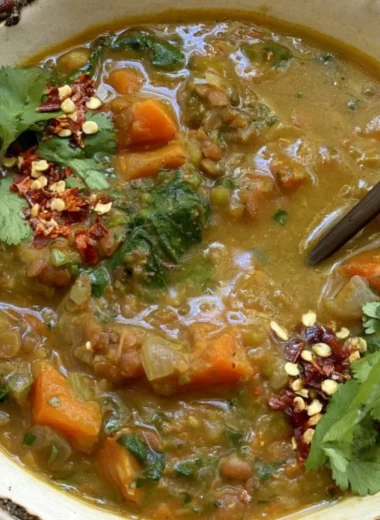 Bowl of Sweet Potato Lentil Stew topped with fresh herbs