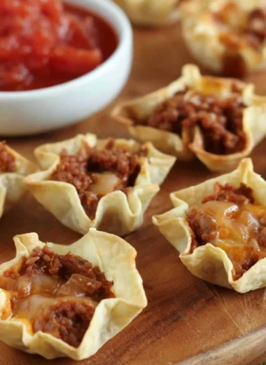 Crispy tortilla nacho cups filled with cheese and toppings