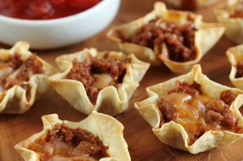 Crispy tortilla nacho cups filled with cheese and toppings